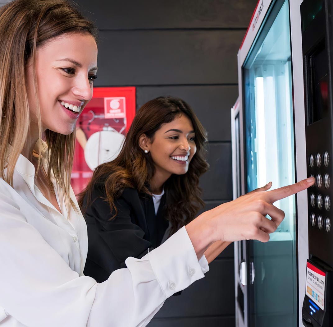 2 girls using vending machine picture